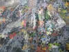 A close-up view of many puzzle pieces inside a clear plastic bag. Produktbild-Vorschau