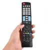 A hand holding a black remote control against a white background. Náhľad obrázku produktu