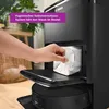 A hand is inserting a dust bag into a black vacuum cleaner base station. Anteprima dell’immagine prodotto