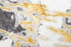 A close-up view of a rug with a marble-like pattern in gray, gold, and white. Produktbild-Vorschau