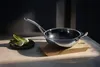 A wok and bok choy on a table. Anteprima dell’immagine prodotto