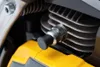 A close-up view of a spark plug on a chainsaw engine. Produktbild-Vorschau