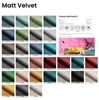 A grid of fabric swatches with color samples and a table of properties, along with a lifestyle image of a living room with a sofa and lamp. Produktbild-Vorschau