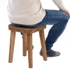 A person sitting on a wooden stool. Náhled obrázku produktu