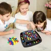 Three children are playing a colorful ball game on a table. Produktbild-Vorschau