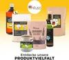 A collection of various food products from the brand mituso, arranged against a bright yellow and orange gradient background. Produktbild-Vorschau