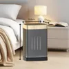 A ceramic heater is placed on a nightstand next to a bed, with a lamp and a book on the nightstand. Produktbild-Vorschau