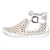 A white ankle boot with a decorative pattern and a buckle. Produktbild-Vorschau