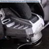 A gloved hand presses a button on a power tool. Produktbild-Vorschau