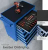 A blue tool cart with several drawers open, displaying various tools and a cordless drill on top. Close-up insets highlight the non-slip surfaces and ball-bearing slides. Náhled obrázku produktu