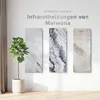Three marble-patterned infrared heating panels are displayed on a white wall next to a potted plant. Produktbild-Vorschau
