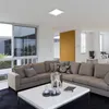 A modern living room with a large sectional sofa, coffee table, and large windows. Podgląd zdjęcia produktu