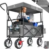 A young girl sits in a foldable wagon filled with items, demonstrating its capacity and use. Produktbild-Vorschau