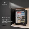 A black retro-style mini-fridge filled with drinks, placed on a countertop next to dark gray cabinets. Produktbild-Vorschau