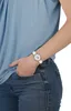 A person wearing a watch and jeans. Produktbild-Vorschau