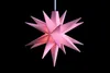 A pink star-shaped lamp hangs against a black background. Produktbild-Vorschau