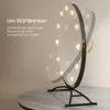 A vanity mirror with lights is shown on a table, with text overlay describing its features. Podgląd zdjęcia produktu