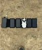 A drone and solar charger laid out on the ground. Produktbild-Vorschau