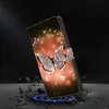 A product shot of a phone case with a butterfly and diamond pattern, presented in a dramatic, almost falling, pose against a dark background. Produktbild-Vorschau