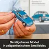 A person's hands are holding a blue model car. Náhľad obrázku produktu