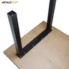 A close-up of black metal table legs attached to a wooden tabletop. Produktbild-Vorschau