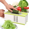 A hand is using a multi-functional grater to shred a cucumber, with a pile of shredded cucumber in a bowl in the foreground and various vegetables in the background. Produktbild-Vorschau