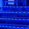 Blue LED strip lights are installed along the edges of wooden steps, illuminating them. Náhľad obrázku produktu