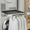 A white drying rack is extended from a washing machine, with four white shirts hanging on it. Podgląd zdjęcia produktu