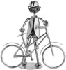 A metallic figurine of a cyclist with a bicycle, presented against a white background. Náhľad obrázku produktu