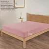 A pink fitted sheet on a wooden bed frame. Produktbild-Vorschau