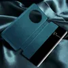 A teal flip phone case with a transparent window is displayed on a dark, silky fabric. Produktbild-Vorschau