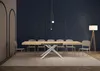A dining room with a large wooden table and chairs, set against a dark blue wall with arched decorative elements. Anteprima dell’immagine prodotto
