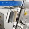 Close-up view of a kitchen faucet with a layered display showing different material finishes and a digital temperature display. Podgląd zdjęcia produktu