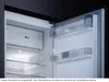 Interior view of an open refrigerator with shelves and drawers. Produktbild-Vorschau