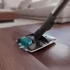A vacuum cleaner head is shown cleaning a wooden floor. Voir les images du produit
