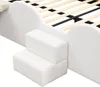 A close-up view of a white upholstered bed frame with two small steps attached to the side. Podgląd zdjęcia produktu