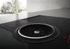 Close-up of a black induction cooktop with a built-in ventilation system. Náhled obrázku produktu