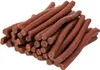 A pile of brown, stick-shaped dog treats. Produktbild-Vorschau