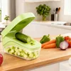 A kitchen counter with a vegetable chopper and fresh vegetables. Náhľad obrázku produktu