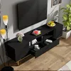 A modern living room scene featuring a black TV stand with gold accents, a television, and decorative items. Produktbild-Vorschau