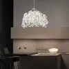 A modern kitchen with a pendant light, bar stools, and a counter with drinks and glasses. Produktbild-Vorschau