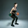 A woman is performing a bicep curl with a barbell in a studio setting. Náhľad obrázku produktu