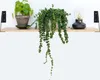 Two potted plants and a decorative lamp are displayed on a wooden shelf mounted on a white wall. Produktbild-Vorschau