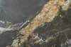 A close-up, abstract view of a textured surface, likely a tabletop or countertop, with swirling patterns of dark gray, gold, and white. Produktbild-Vorschau