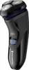 A black electric shaver with a blue power button and silver shaving heads is shown against a white background. Voir les images du produit