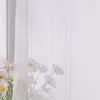 A sheer white curtain with vertical stripes, partially obscuring a bouquet of light pink and white daisy-like flowers in the foreground. Produktbild-Vorschau