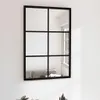 A black metal framed mirror with multiple panes, mounted on a white wall. Náhľad obrázku produktu