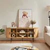 A living room scene featuring a wooden media console with decorative items and artwork. Náhľad obrázku produktu