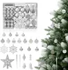 A set of Christmas ornaments is displayed next to a decorated Christmas tree. Voir les images du produit