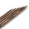 A close-up, diagonal view of several wooden knitting needles with a marbled brown and black pattern. Produktbild-Vorschau